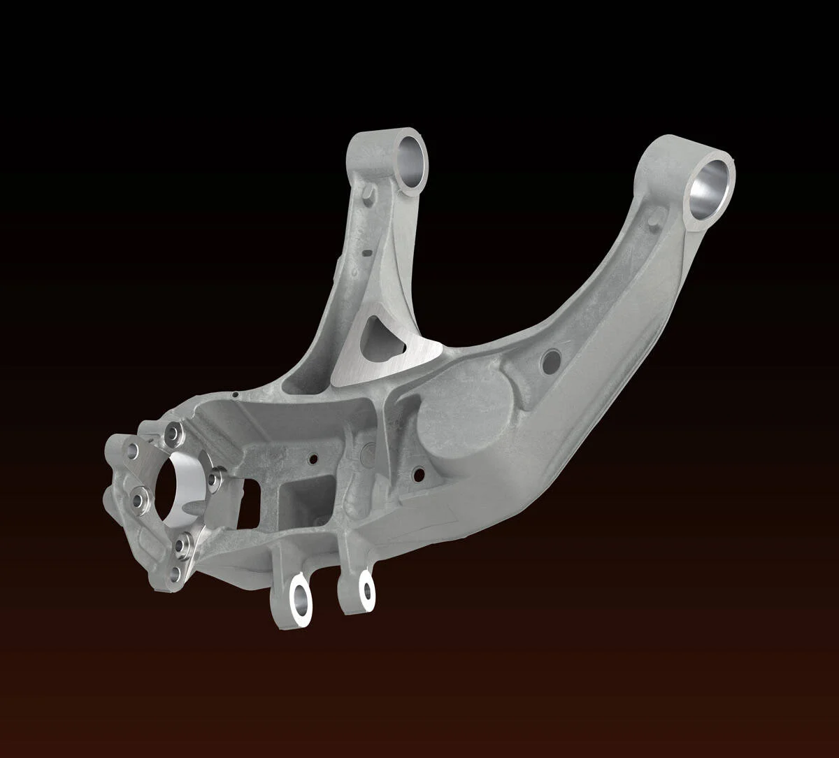 Close-up image of a silver metallic automotive suspension control arm part isolated on a black background.