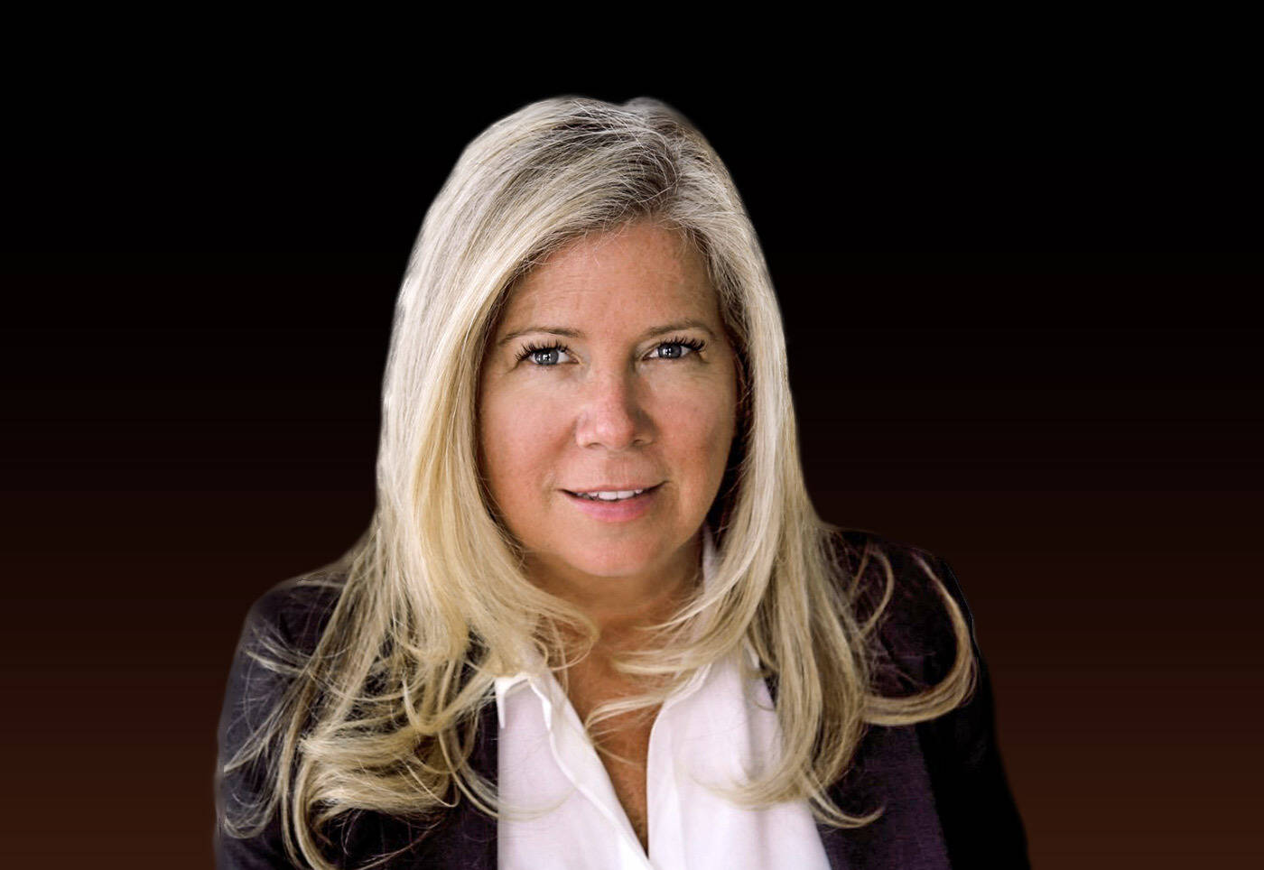 Portrait of a confident blonde woman wearing a white blouse and dark blazer against a black background.
