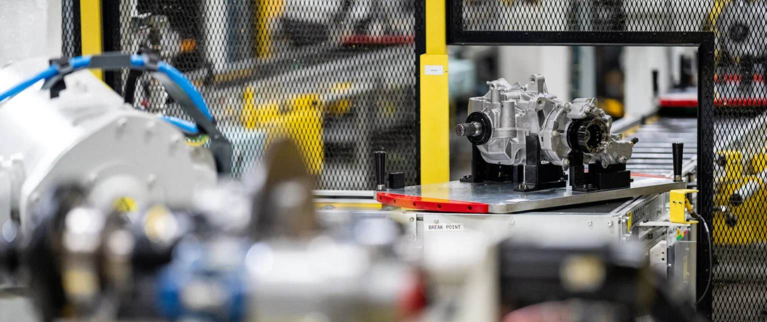 Close-up of mechanical parts and machinery components in an industrial manufacturing setting with a focus on precision assembly.