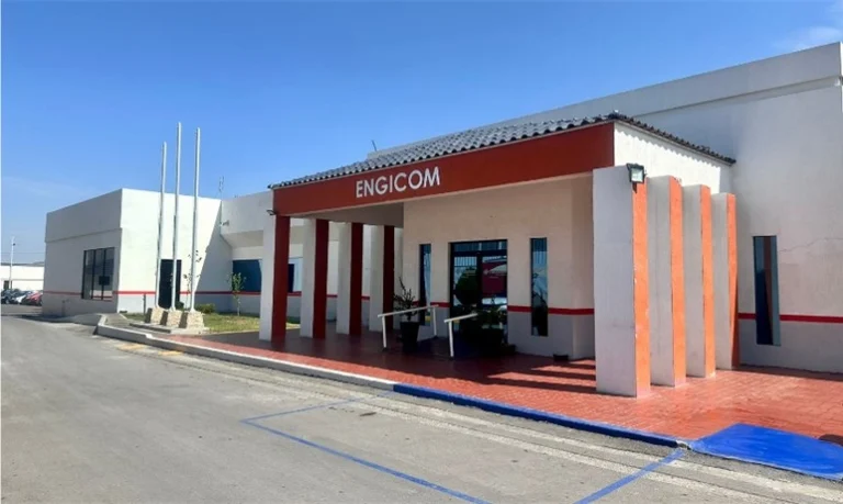 Exterior view of the modern Engicom office building with a red entrance canopy and clear blue sky.