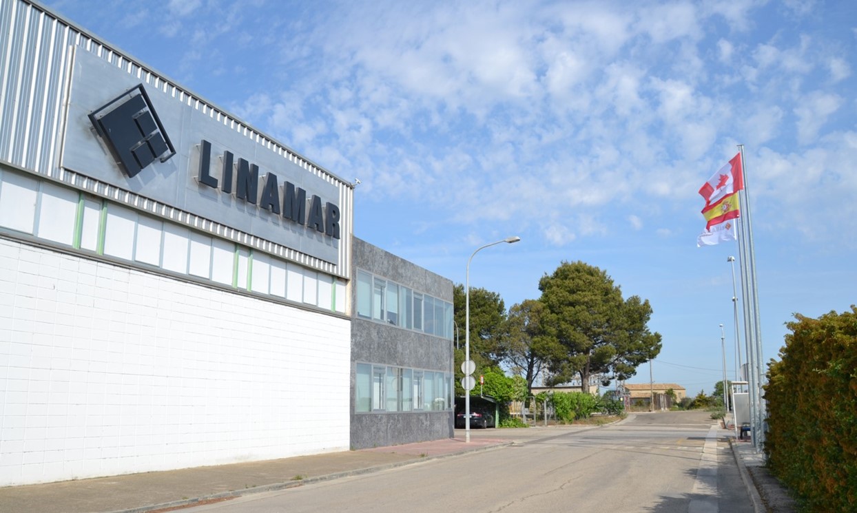 Exterior view of the Limano building under a partly cloudy sky with a clear street and trees in the background.