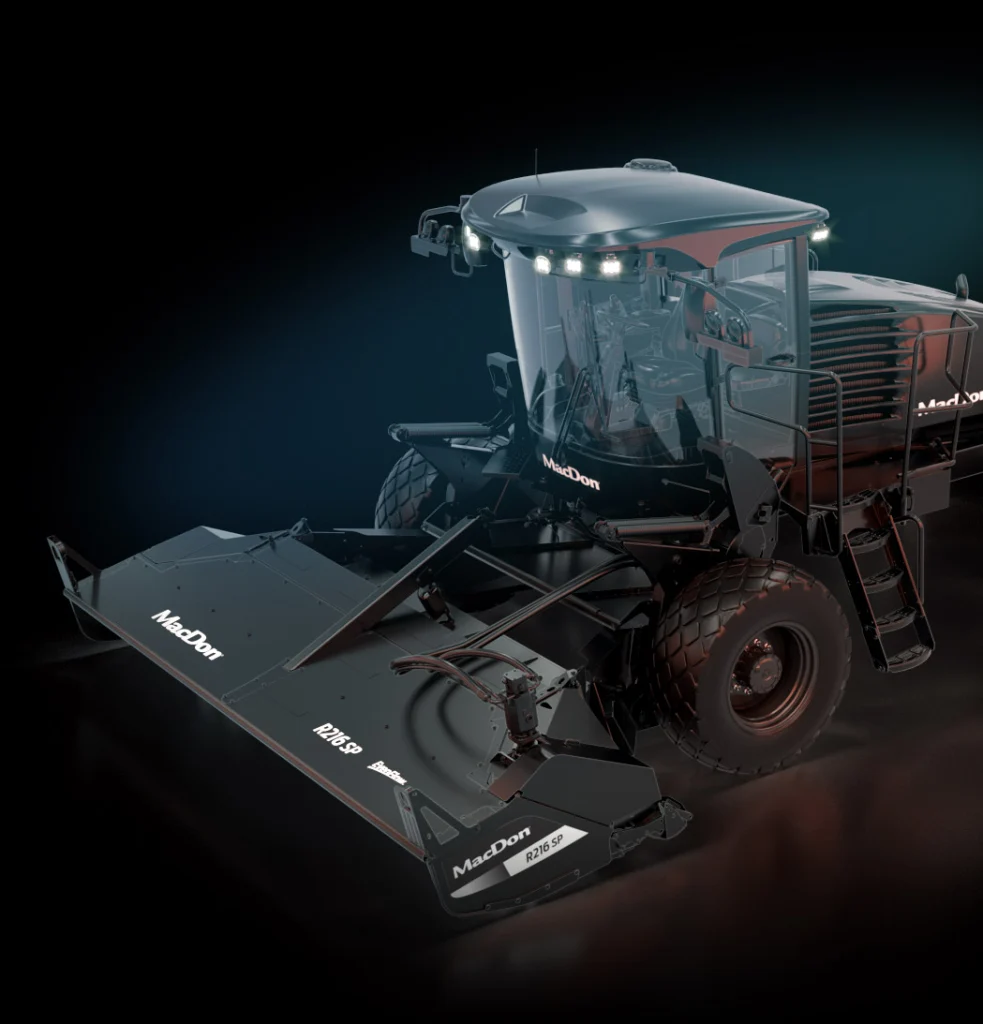 Modern large agricultural harvester with wide cutting header and enclosed cab, shown on a dark background.